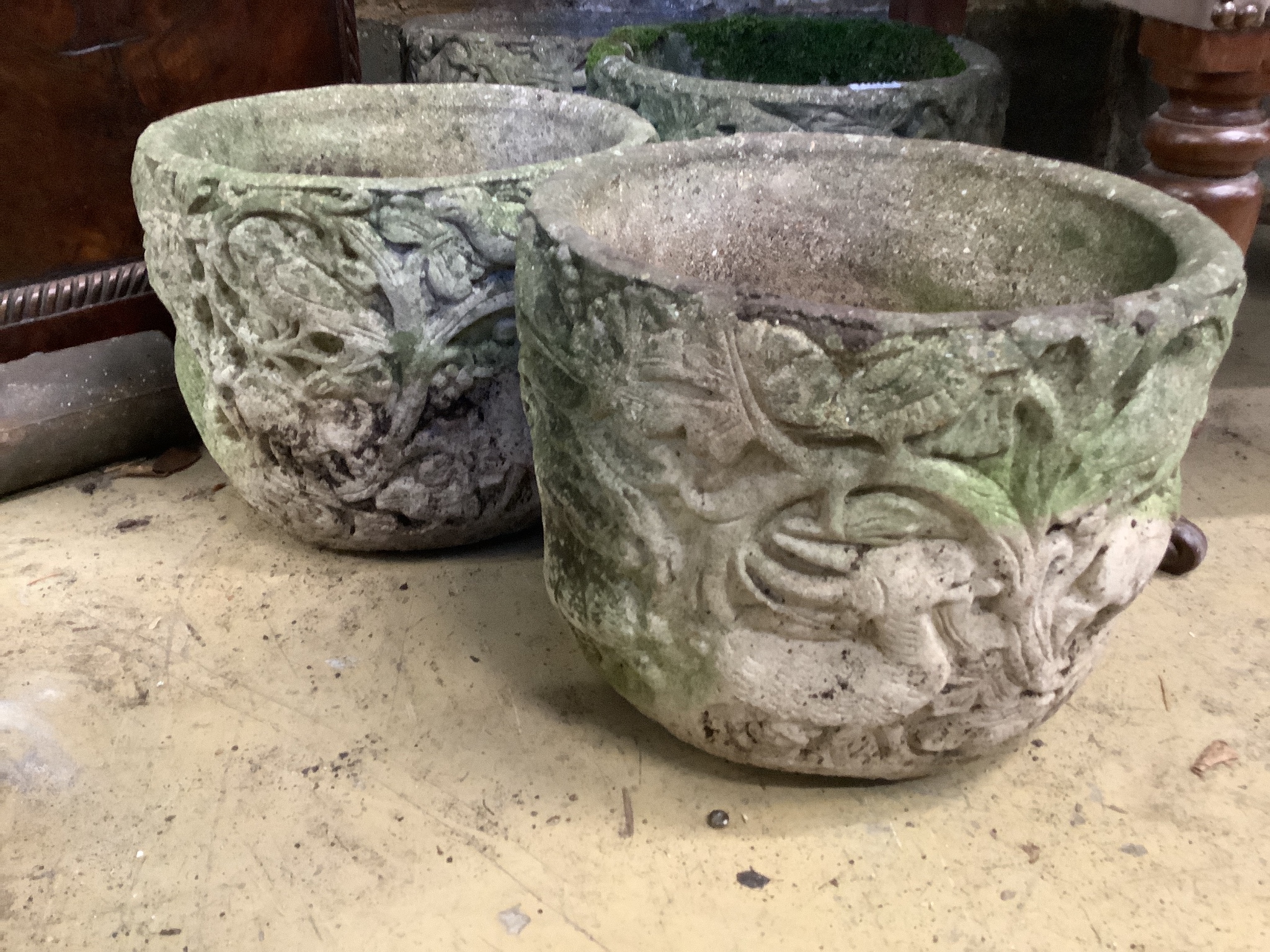 A set of four circular reconstituted stone garden planters, diameter 29cm, height 23cm